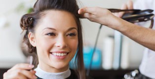 Smiling woman getting her hair styled